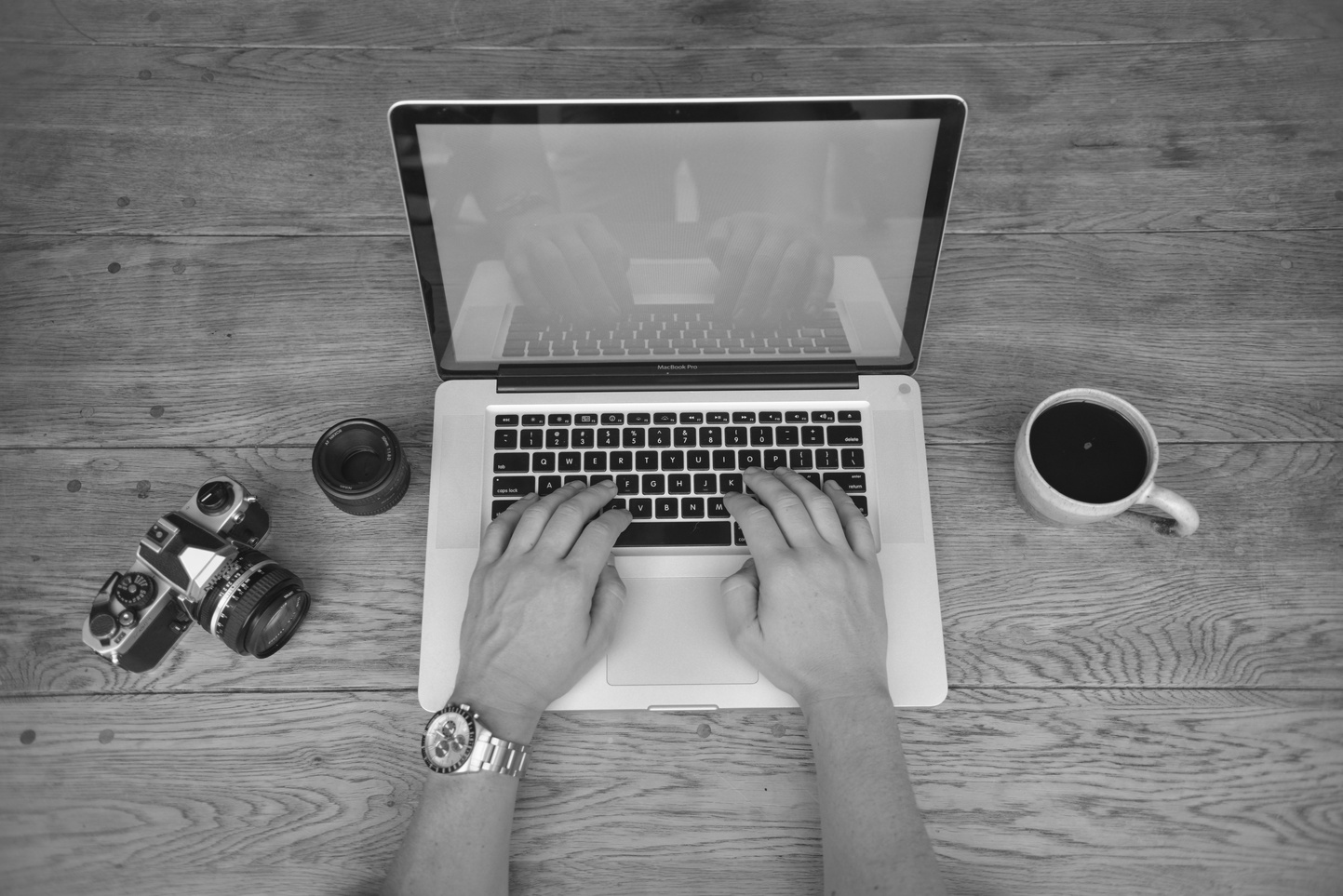Gray Scale Photography of a Person Using Laptop